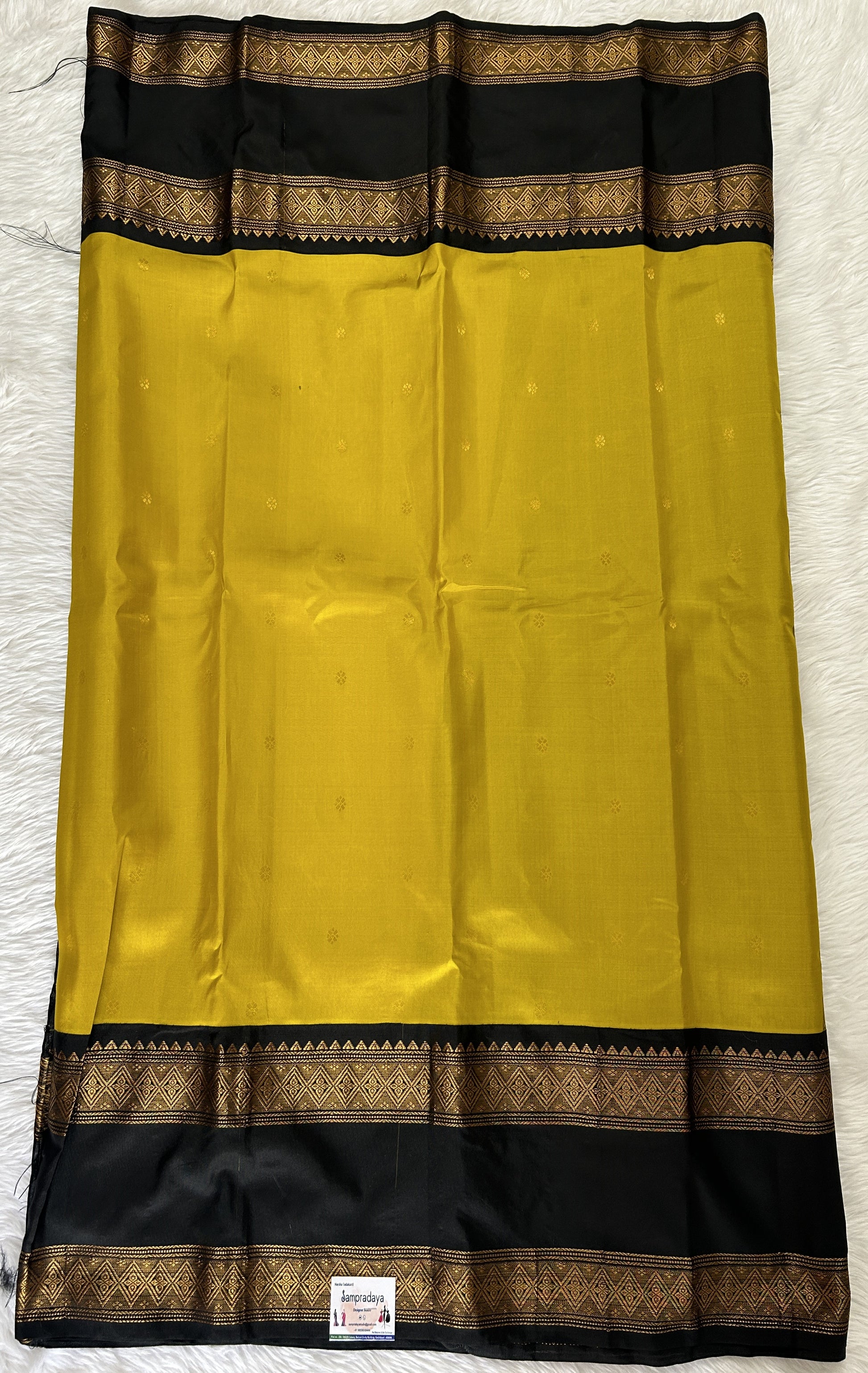 Gadwal Pattu Saree Mustard Yellow colored saree complemented with a Black Kanchi Gap Border - Sampradaya Designer Studio