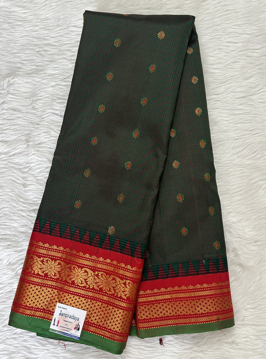 Gadwal Pattu Saree Forest Green colored saree complemented with a Dark Red Kanchi Border - Sampradaya Designer Studio
