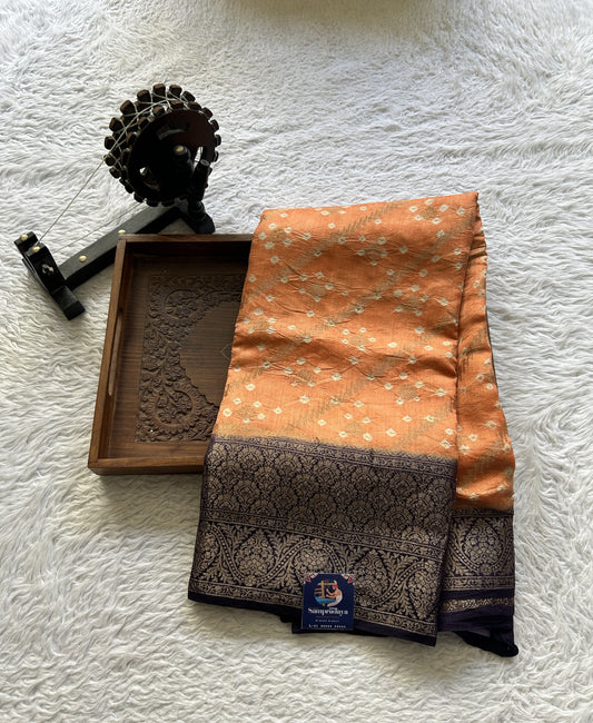 Bandhani Saree Pale Orange Colored Elegantly Paired with a Navy Blue Color Zari Border. - Sampradaya Designer Studio