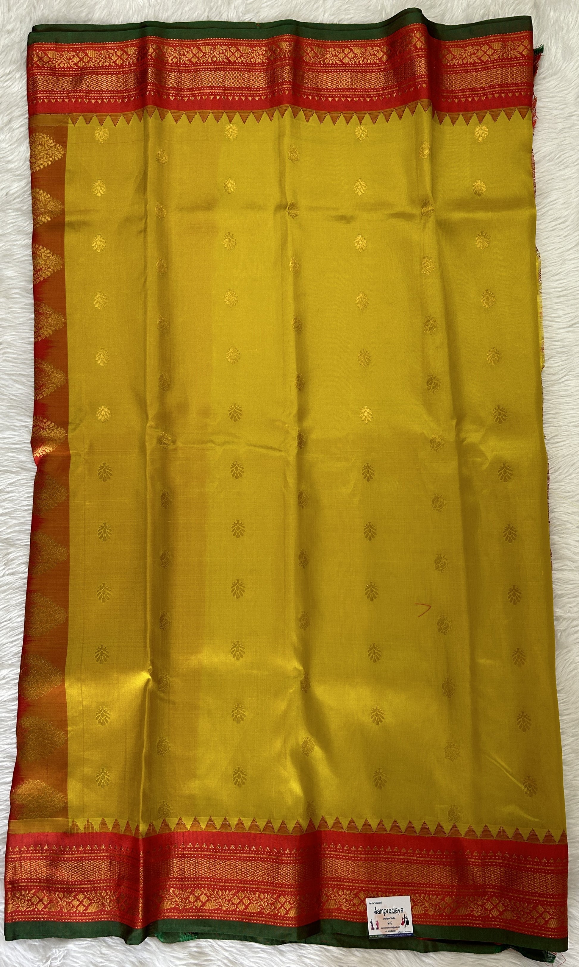 Gadwal Pattu Saree Yellow colored saree complemented with a Red Kanchi Border - Sampradaya Designer Studio