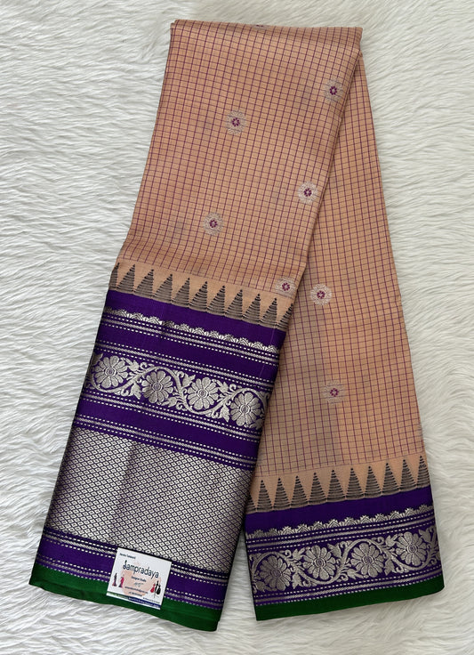 Gadwal Pattu Saree Light Peach colored saree complemented with a Violet Kanchi Border - Sampradaya Designer Studio