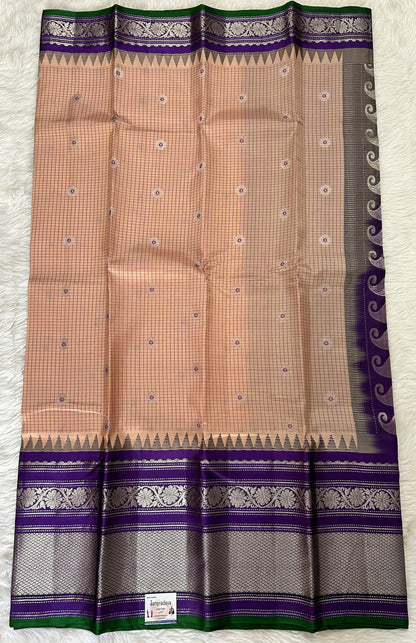 Gadwal Pattu Saree Light Peach colored saree complemented with a Violet Kanchi Border - Sampradaya Designer Studio
