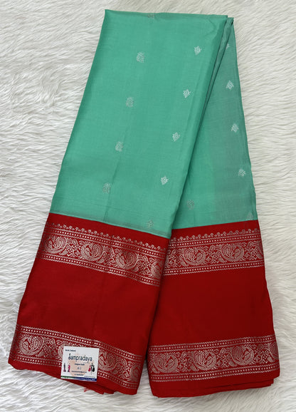 Gadwal Pattu Saree Mint Green colored saree complemented with a Red Kanchi Gap Border - Sampradaya Designer Studio