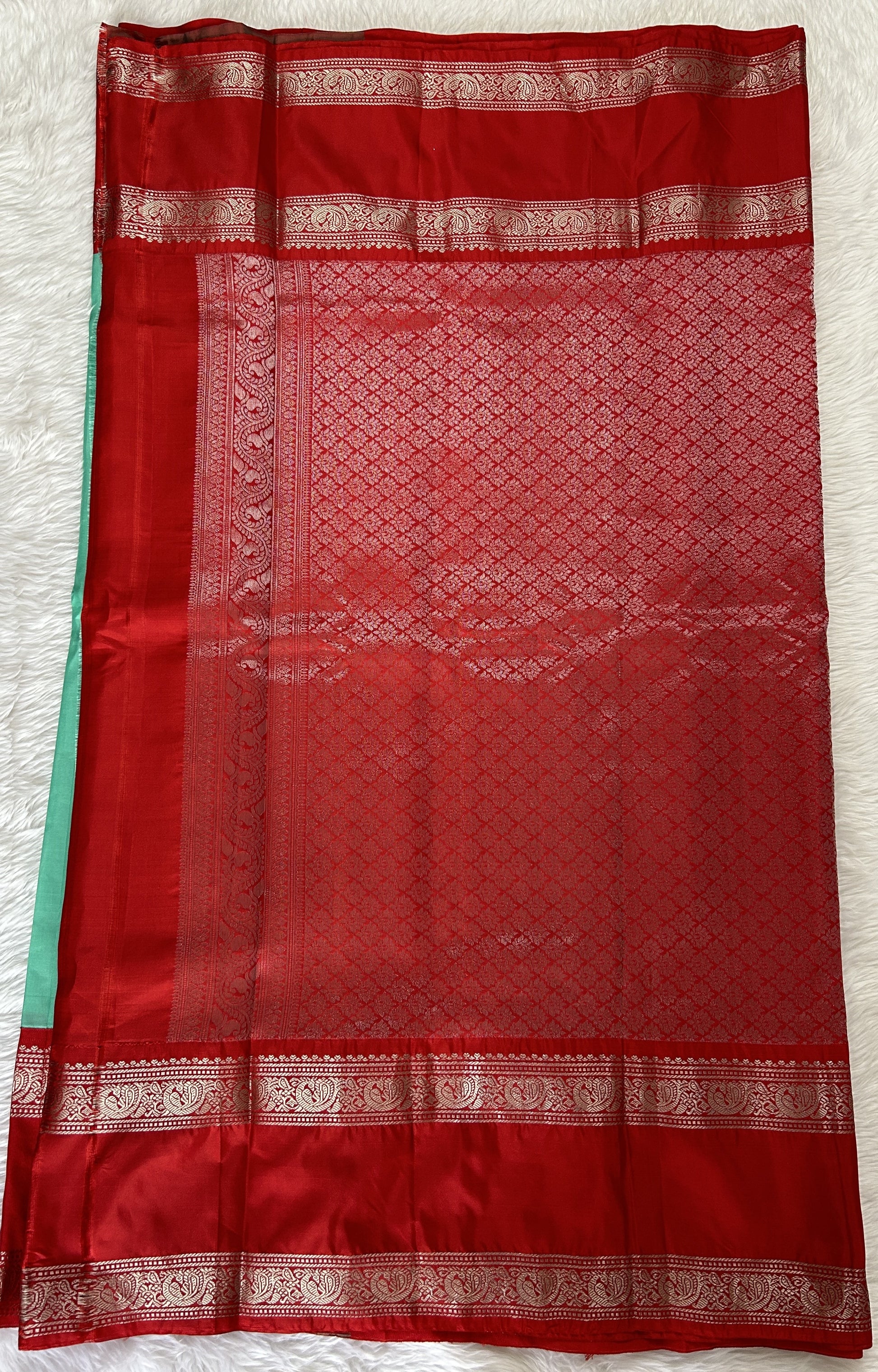 Gadwal Pattu Saree Mint Green colored saree complemented with a Red Kanchi Gap Border - Sampradaya Designer Studio