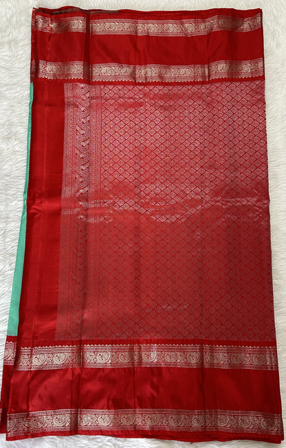 Gadwal Pattu Saree Mint Green colored saree complemented with a Red Kanchi Gap Border - Sampradaya Designer Studio