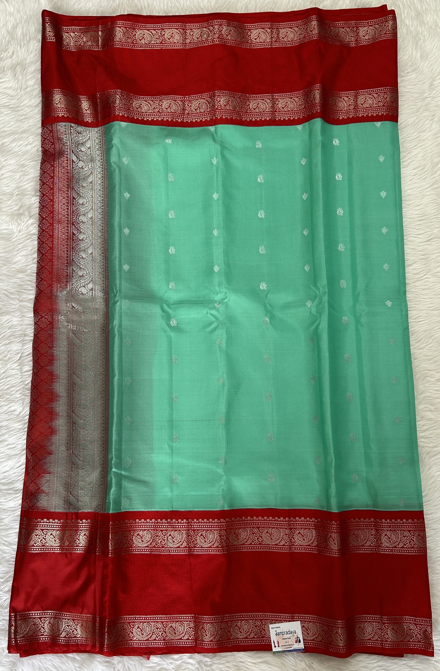 Gadwal Pattu Saree Mint Green colored saree complemented with a Red Kanchi Gap Border - Sampradaya Designer Studio