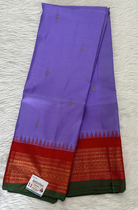 Gadwal Pattu Saree Lavender colored saree complemented with a Red Kanchi Border - Sampradaya Designer Studio