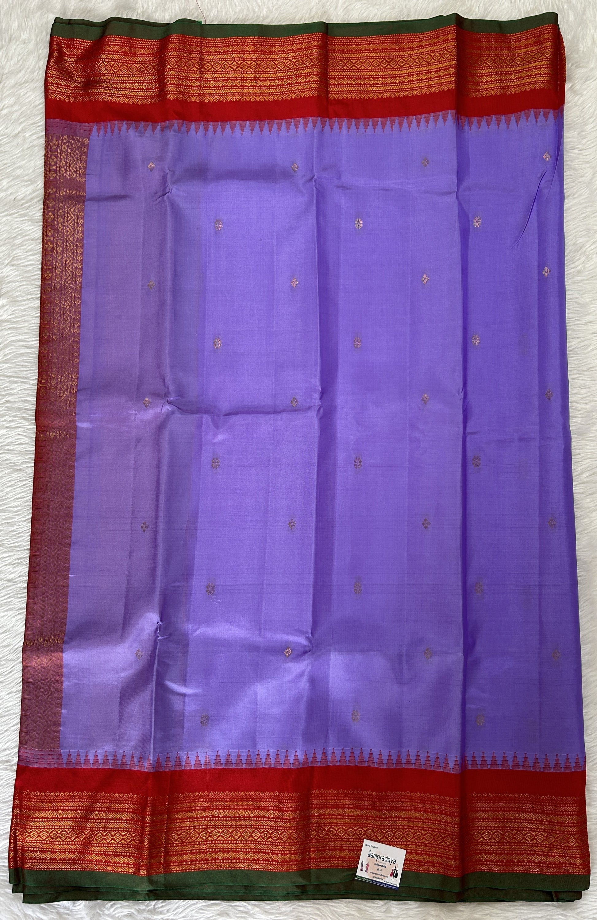 Gadwal Pattu Saree Lavender colored saree complemented with a Red Kanchi Border - Sampradaya Designer Studio