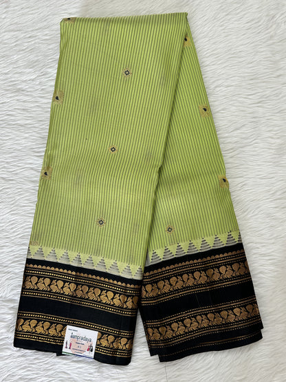 Gadwal Pattu Saree Pastel Green colored saree complemented with a Black Kanchi Gap Border - Sampradaya Designer Studio
