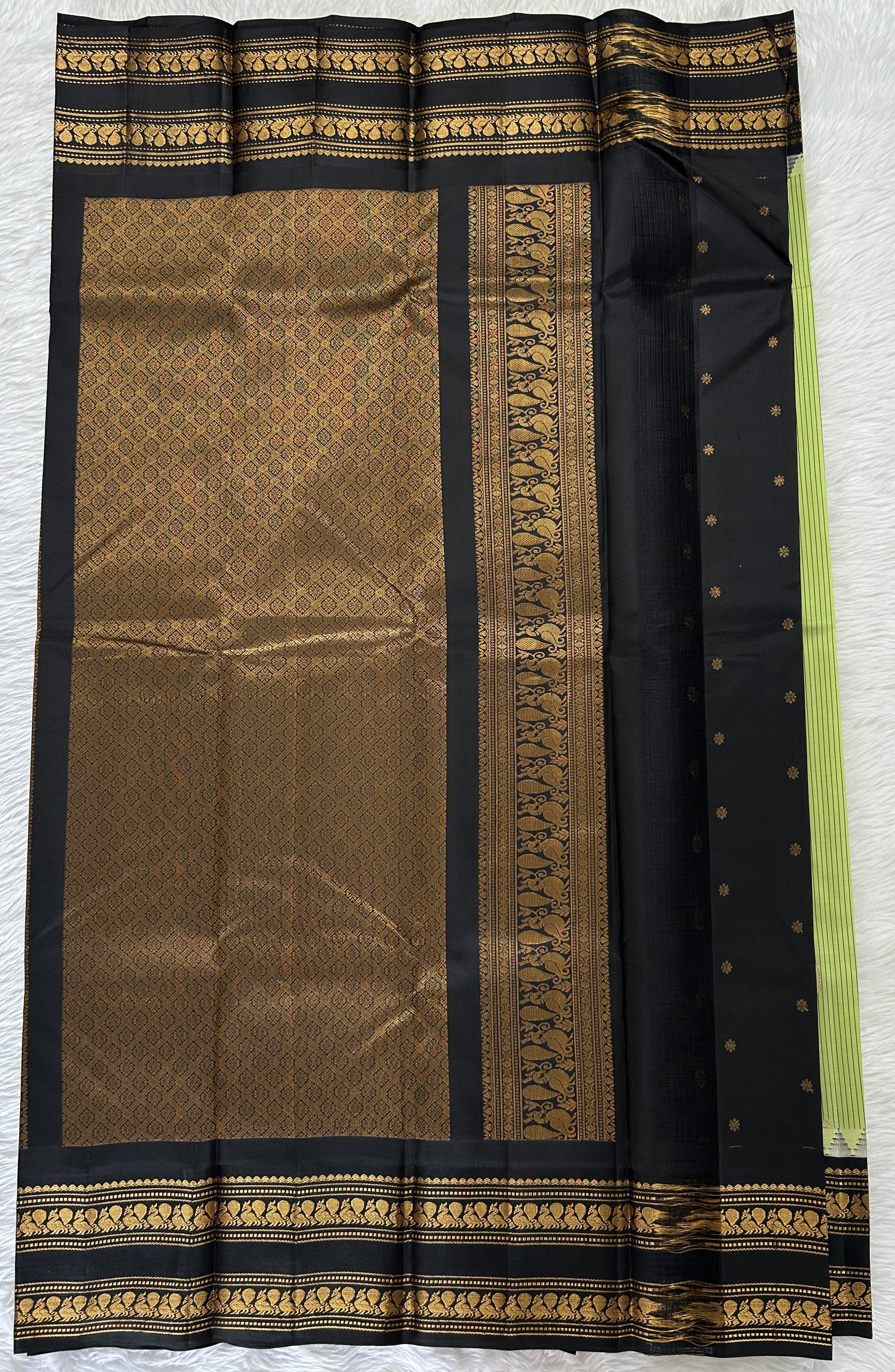 Gadwal Pattu Saree Pastel Green colored saree complemented with a Black Kanchi Gap Border - Sampradaya Designer Studio