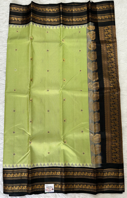 Gadwal Pattu Saree Pastel Green colored saree complemented with a Black Kanchi Gap Border - Sampradaya Designer Studio