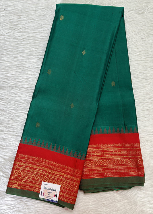 Gadwal Pattu Saree Dark Green colored saree complemented with a Red Kanchi Border - Sampradaya Designer Studio