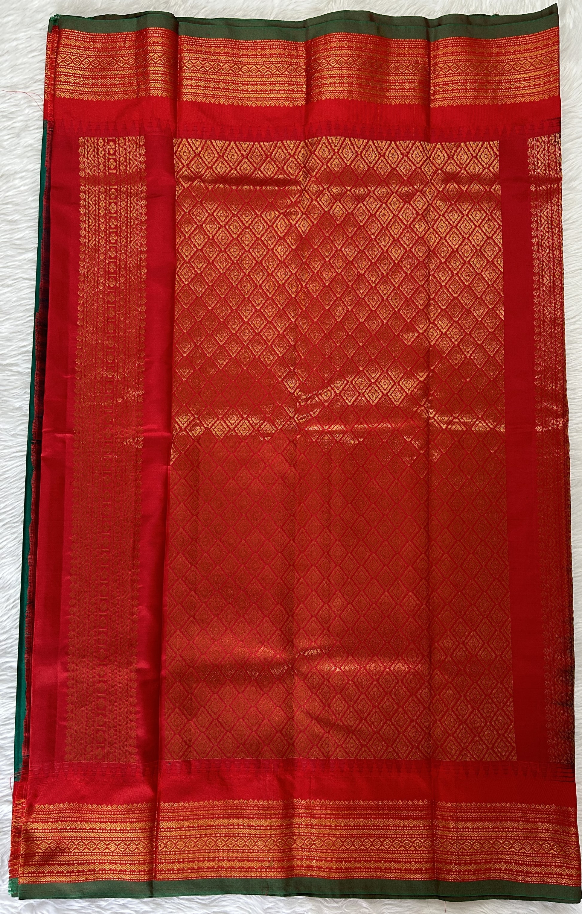 Gadwal Pattu Saree Dark Green colored saree complemented with a Red Kanchi Border - Sampradaya Designer Studio