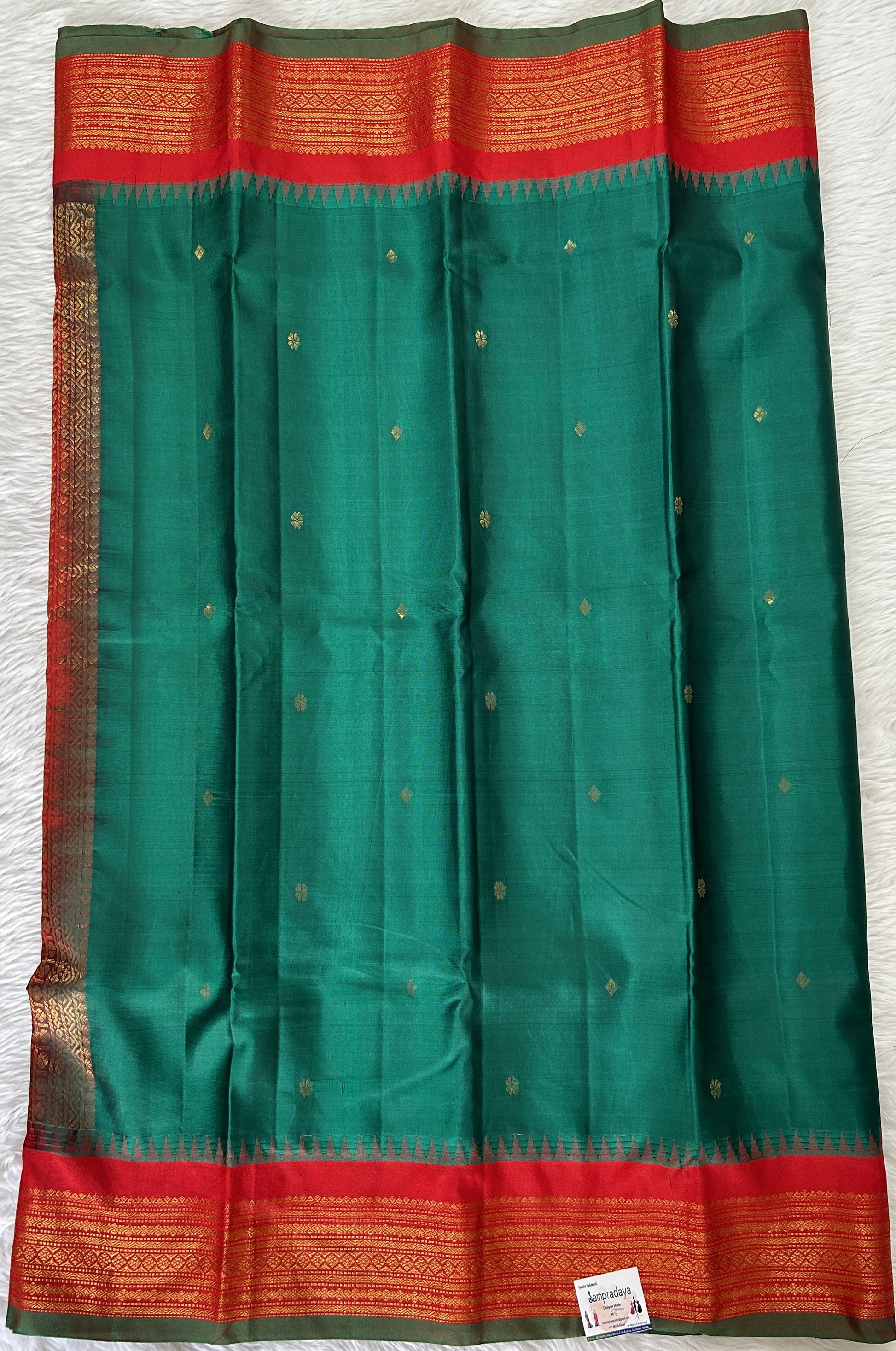 Gadwal Pattu Saree Dark Green colored saree complemented with a Red Kanchi Border - Sampradaya Designer Studio