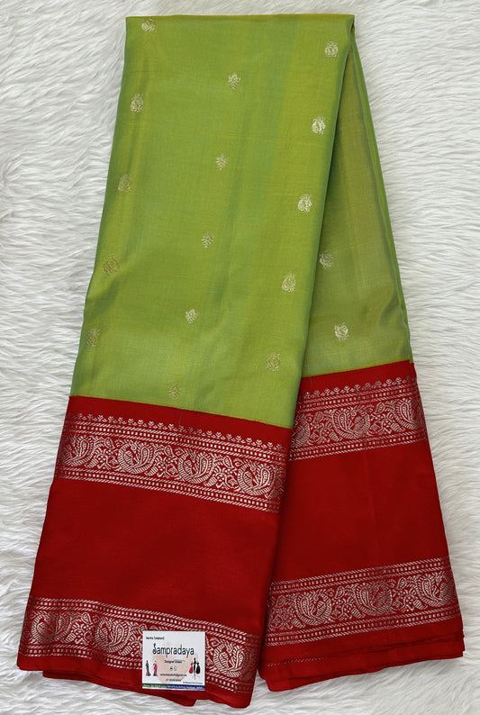 Gadwal Pattu Saree Avocado Green colored saree complemented with a Red Kanchi Gap Border - Sampradaya Designer Studio