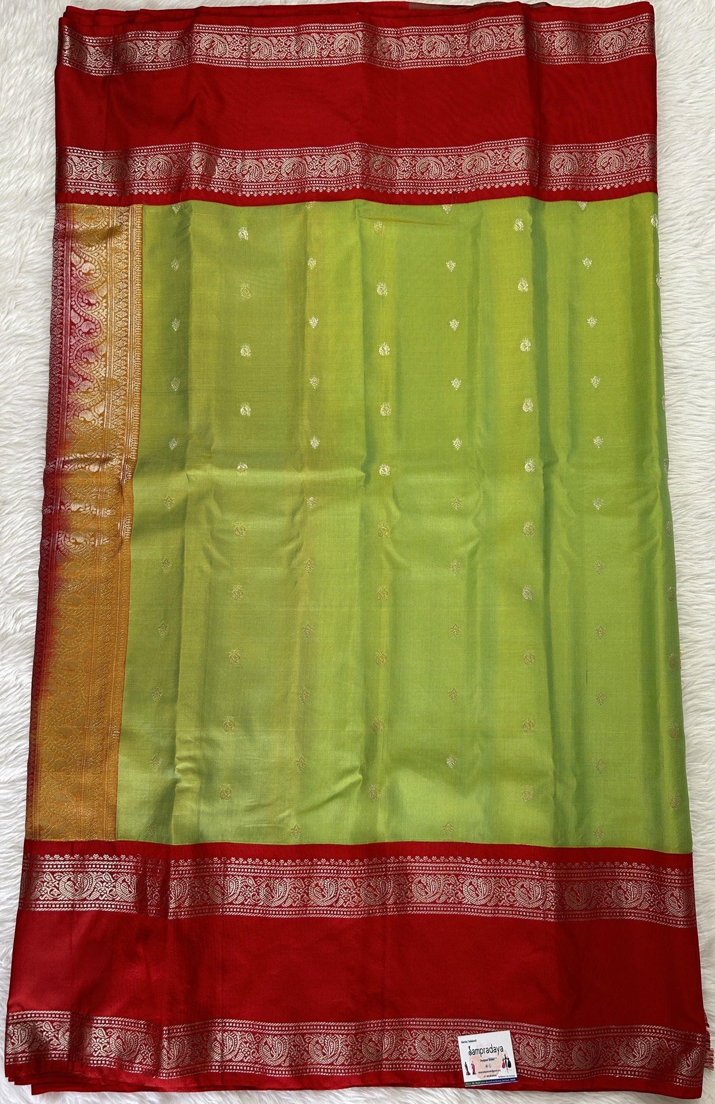 Gadwal Pattu Saree Avocado Green colored saree complemented with a Red Kanchi Gap Border - Sampradaya Designer Studio