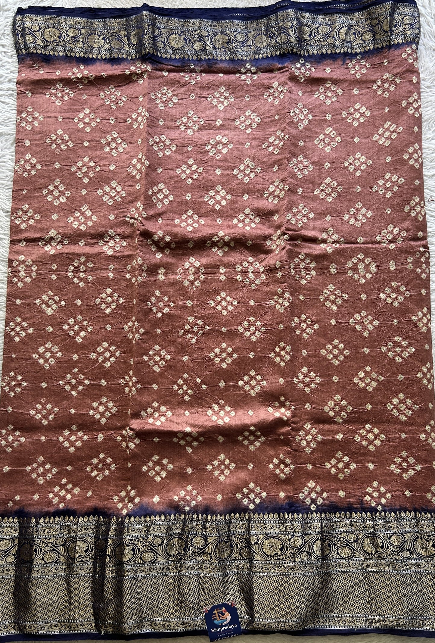 Bandhani Saree Brick Colored Elegantly Paired with a Navy Blue Color Zari Border. - Sampradaya Designer Studio