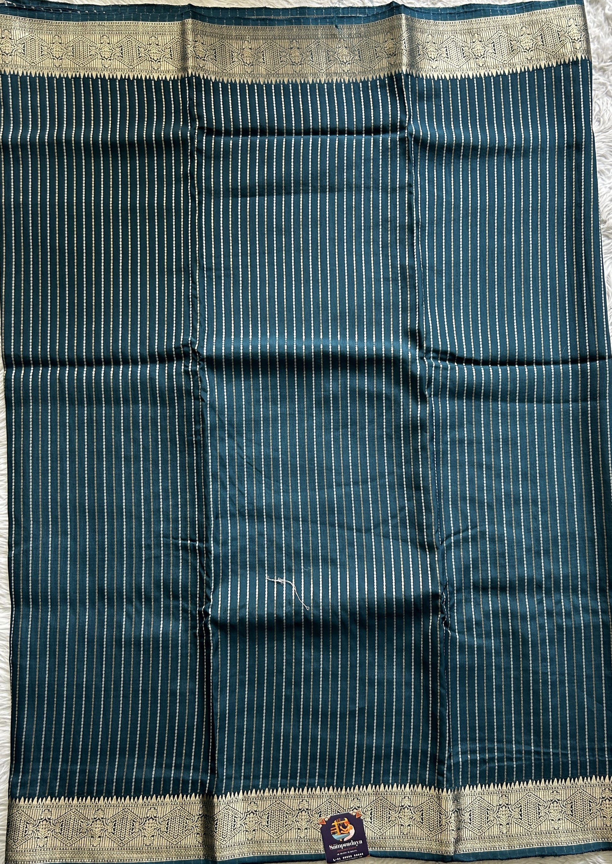 Semi Georgette Saree Peacock Blue Colored Complemented with a Zari Border. - Sampradaya Designer Studio