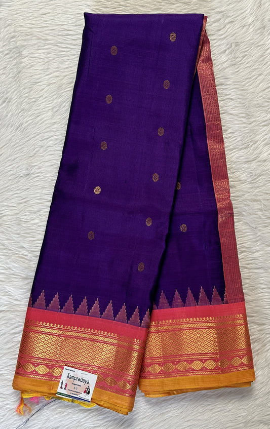 Gadwal Pattu Dark Violet Colored Saree Complemented With a Pattu Peach Color Kanchi Border - Sampradaya Designer Studio