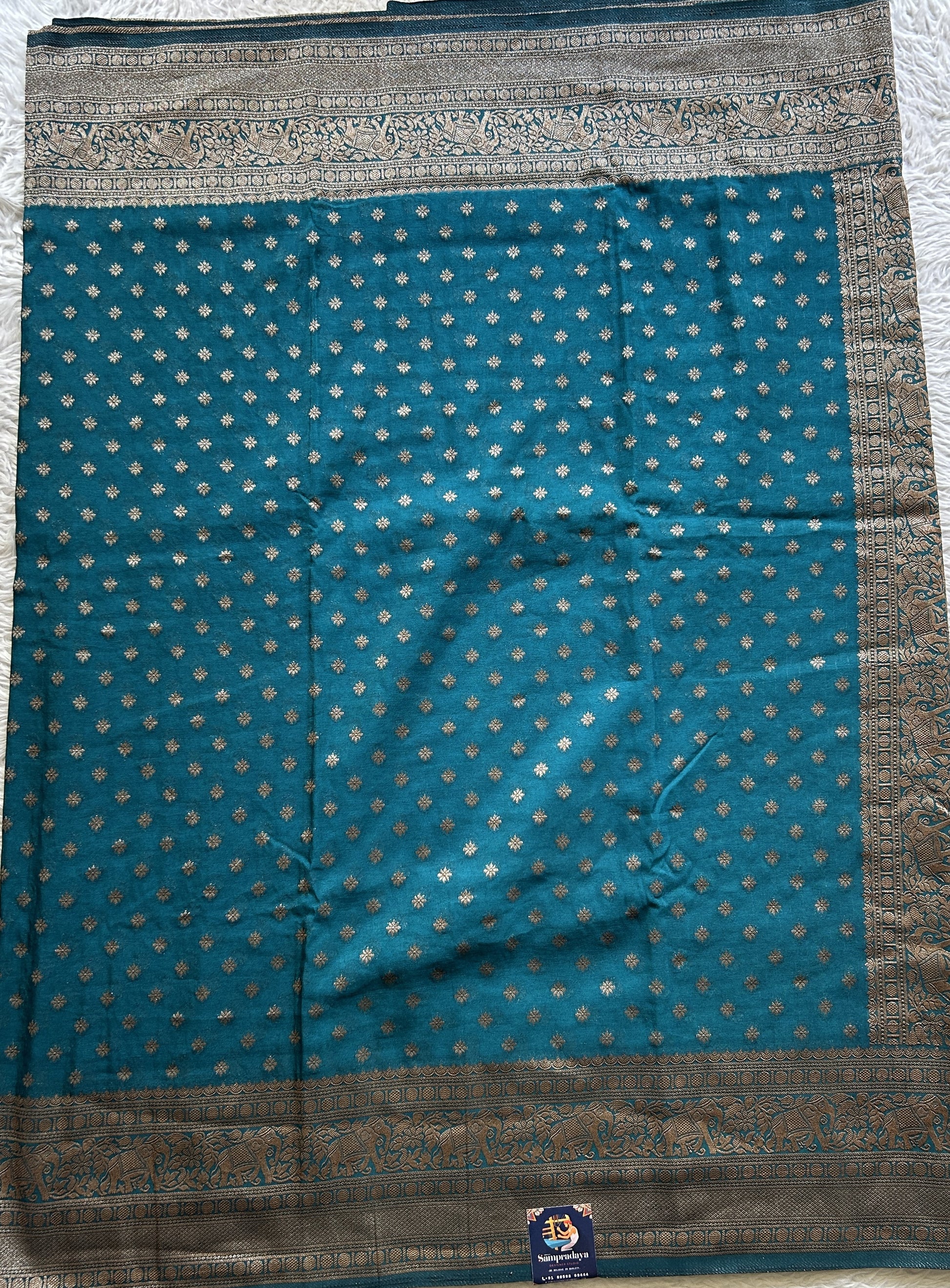Semi Georgette Saree Teal Blue Colored Elegantly Paired with a Zari Border. - Sampradaya Designer Studio