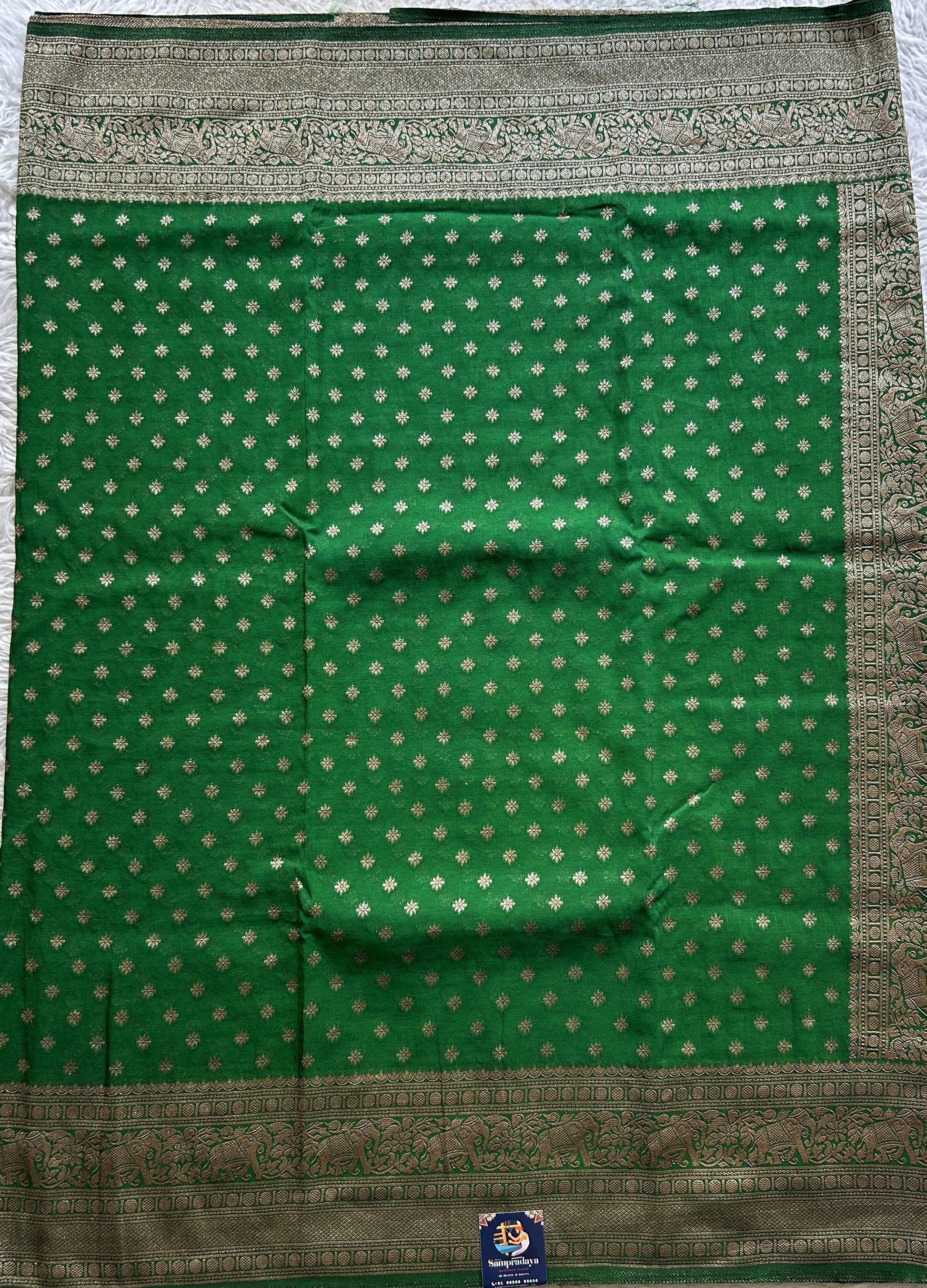 Semi Georgette Saree Leaf Green Colored Complemented with a Zari Border. - Sampradaya Designer Studio