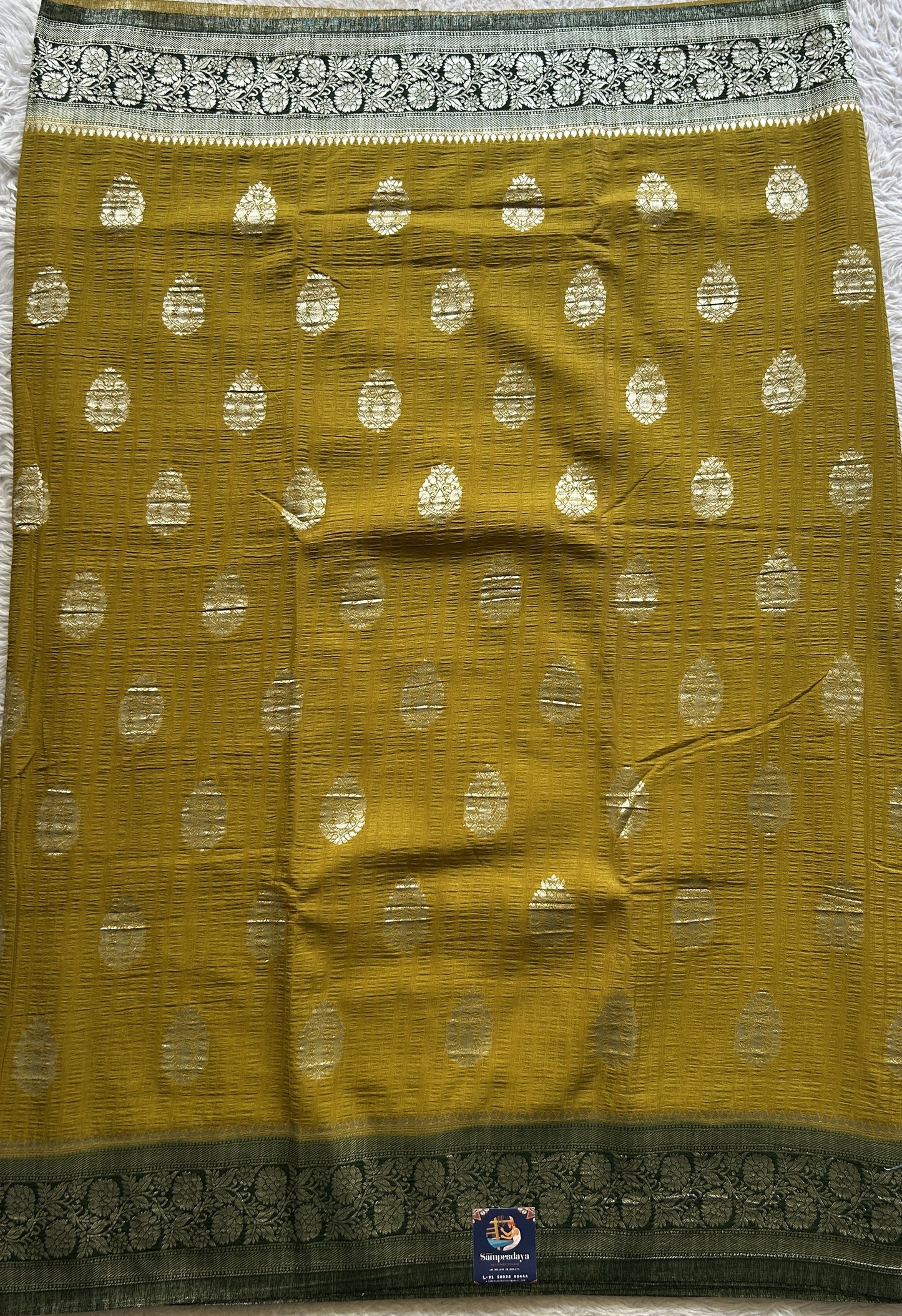Semi Georgette Saree Mustard Colored Complemented with a Green Zari Border. - Sampradaya Designer Studio