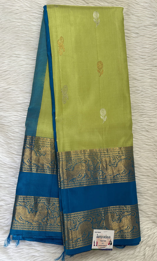 Gadwal Pattu Parrot Green Colored Saree Complemented With a Pattu Blue Color Kanchi Gap Border - Sampradaya Designer Studio