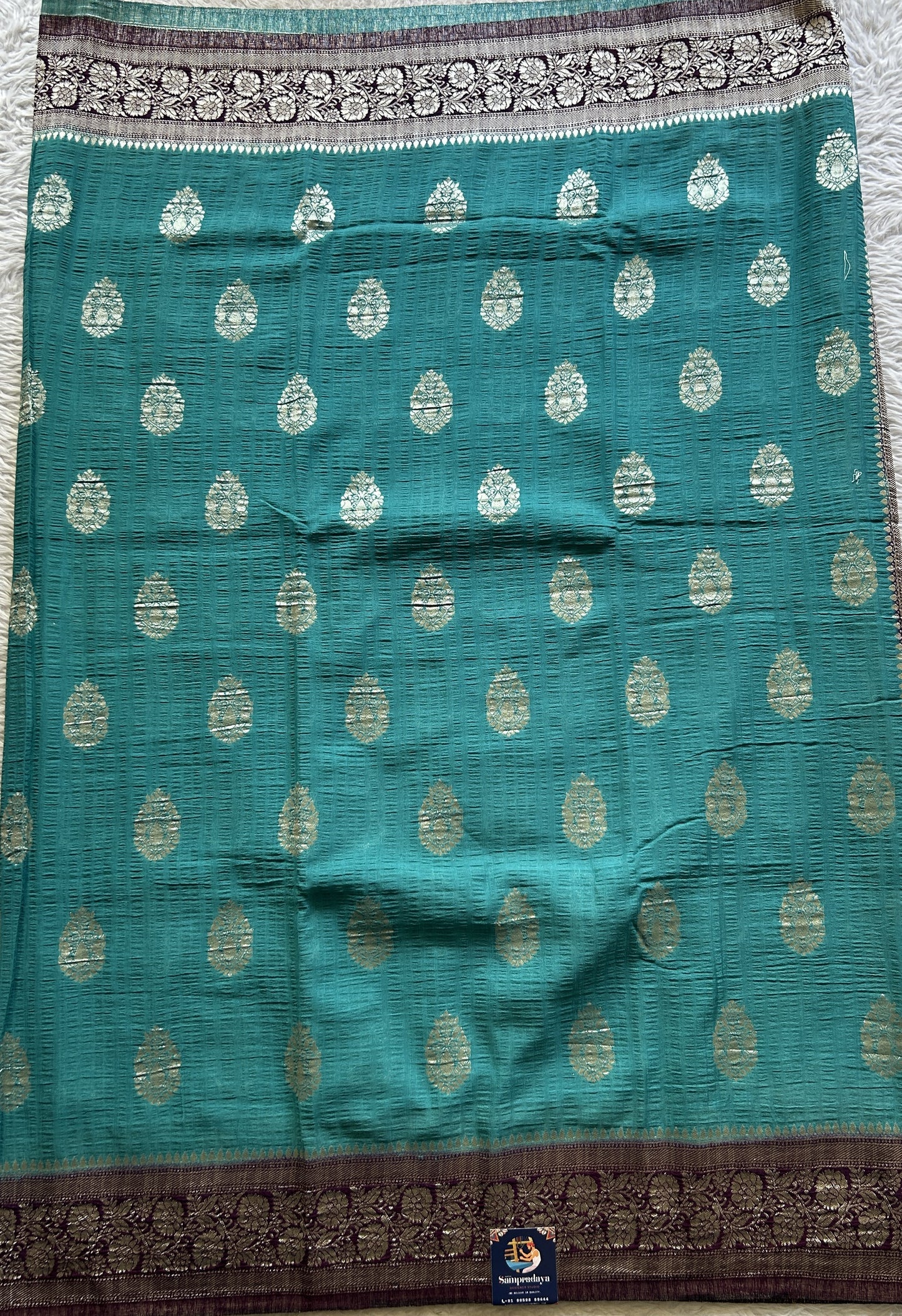 Semi Georgette Saree Aqua Blue Colored Complemented with a Purple Zari Border. - Sampradaya Designer Studio