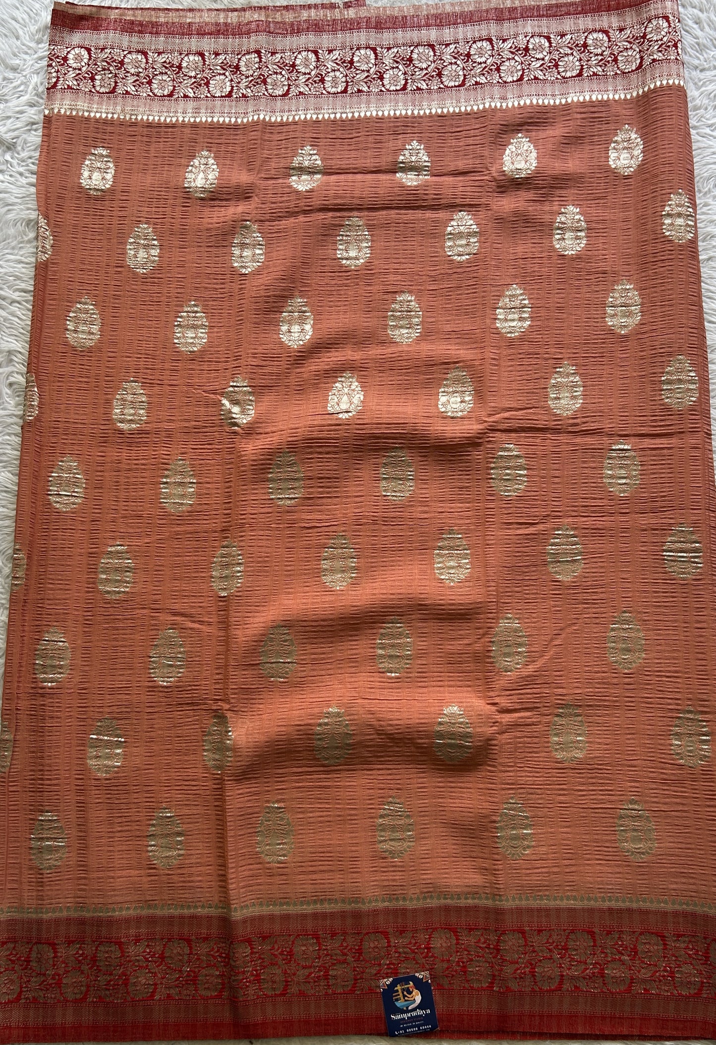 Semi Georgette Saree Pale Orange Colored Complemented with a Zari Border. - Sampradaya Designer Studio