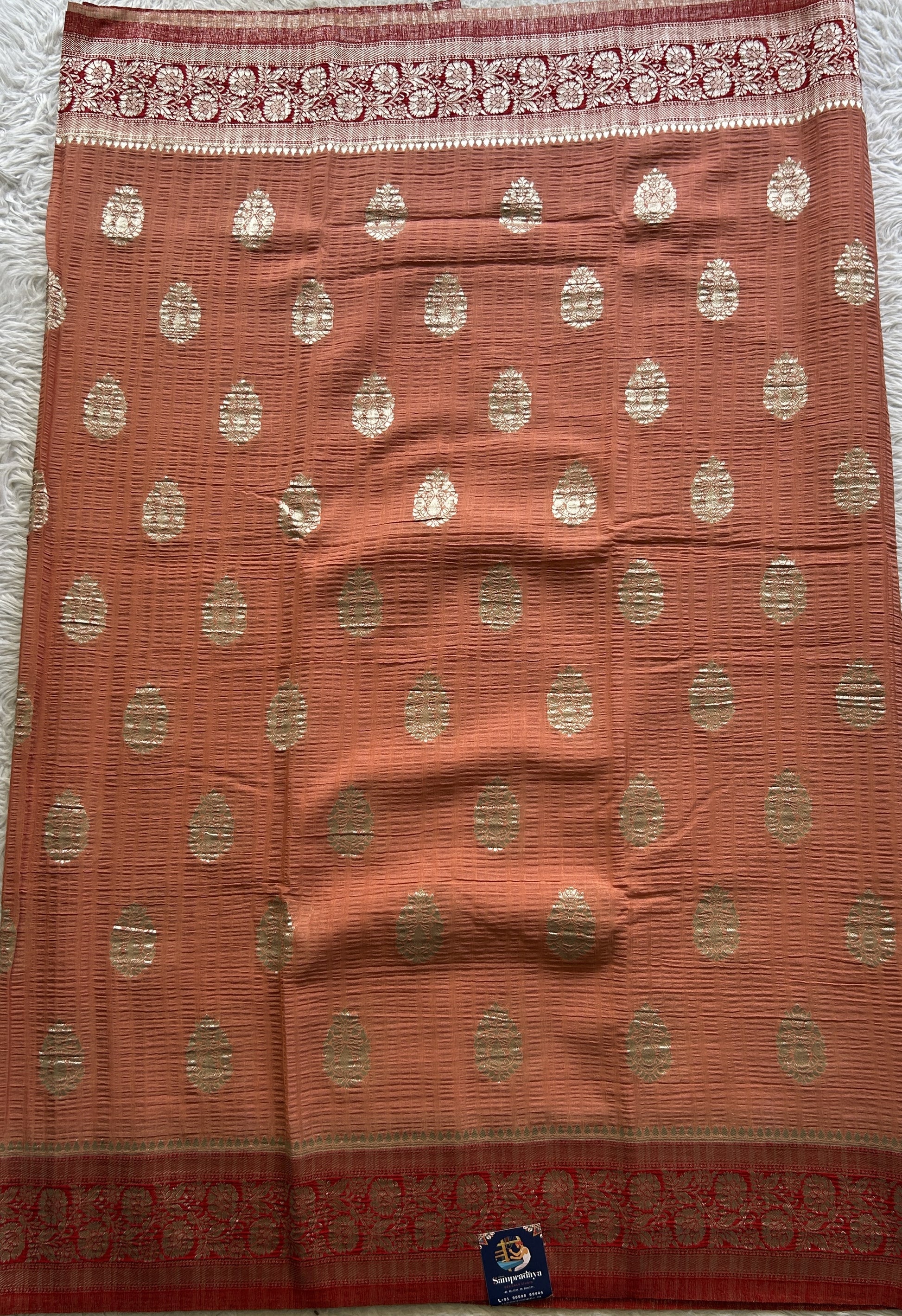 Semi Georgette Saree Pale Orange Colored Complemented with a Zari Border. - Sampradaya Designer Studio