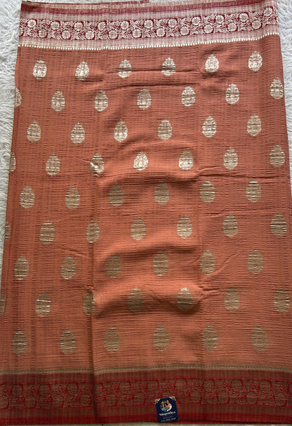 Semi Georgette Saree Pale Orange Colored Complemented with a Zari Border. - Sampradaya Designer Studio