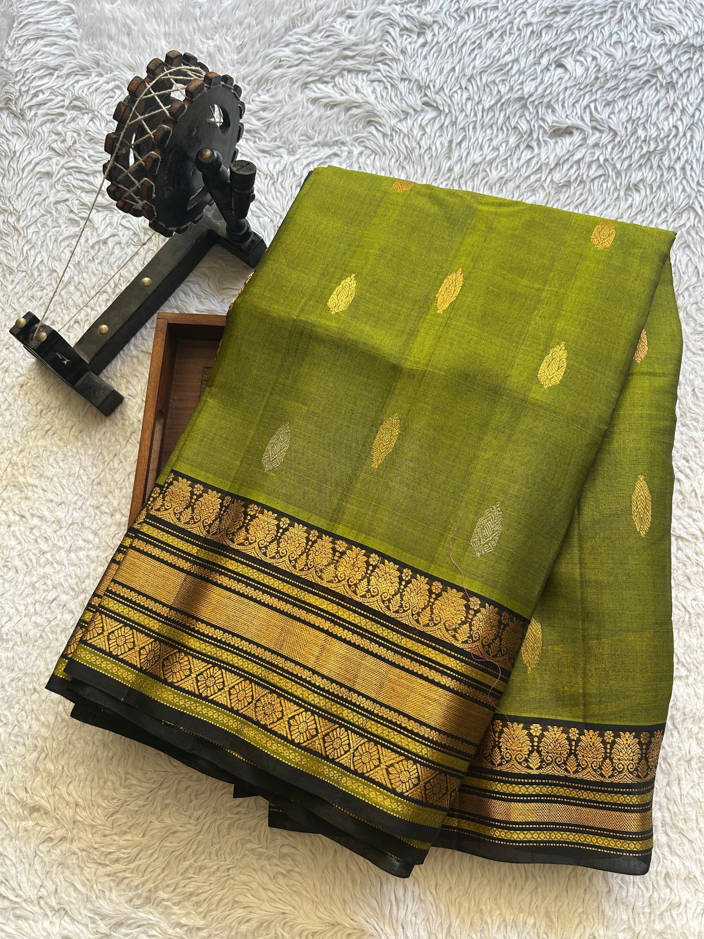Gadwal Sico Saree Olive Green colored complemented with a Gold Zari Border
