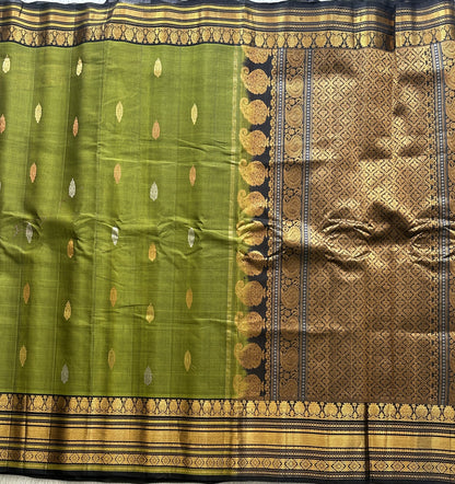 Gadwal Sico Saree Olive Green colored complemented with a Gold Zari Border