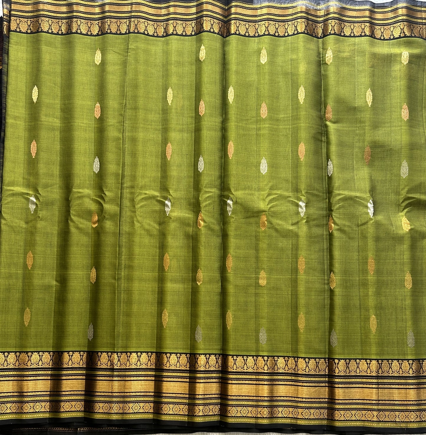 Gadwal Sico Saree Olive Green colored complemented with a Gold Zari Border