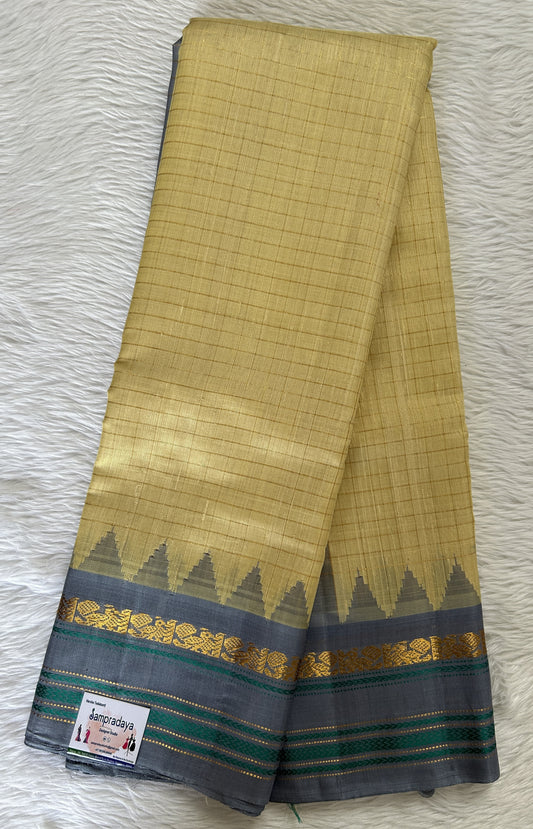 Gadwal Pattu Pastel Yellow Colored Saree Complemented With a Pattu Gray Color Gap Border - Sampradaya Designer Studio