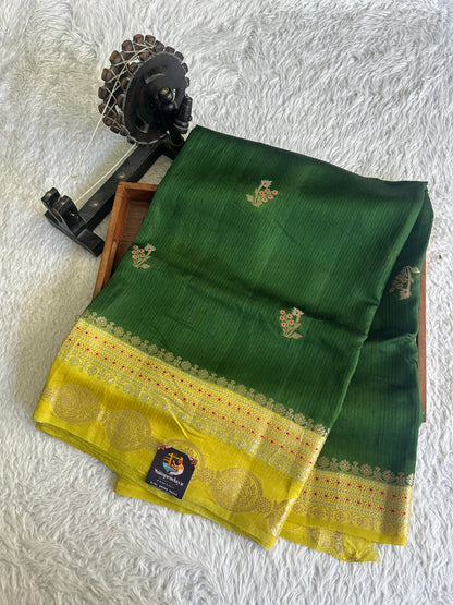 Banarasi Fancy Saree Jungle Green Colored Complemented with a Gold Zari Border.