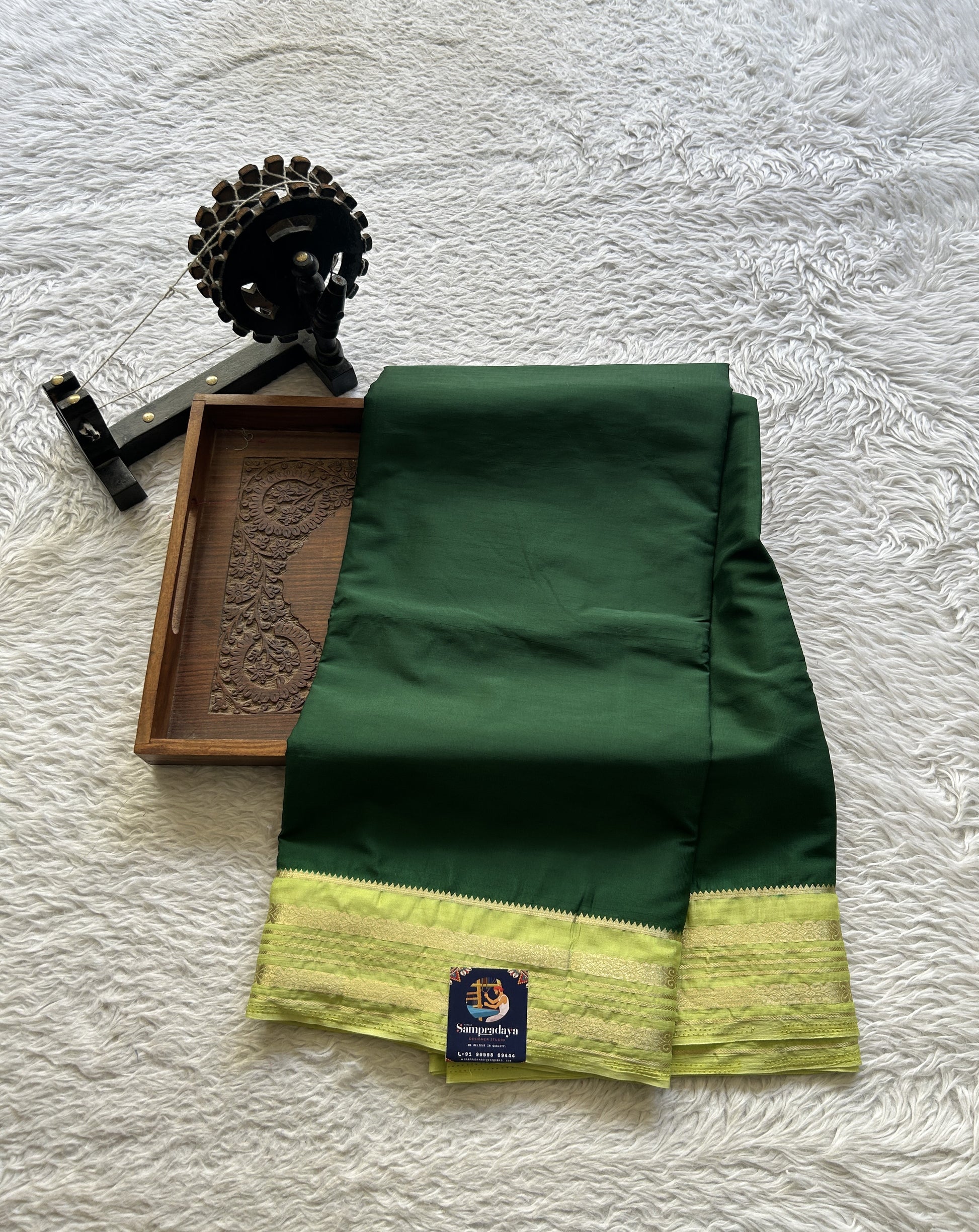 Semi Georgette Saree Dark Green Colored elegantly adorned with a Zari Border. - Sampradaya Designer Studio