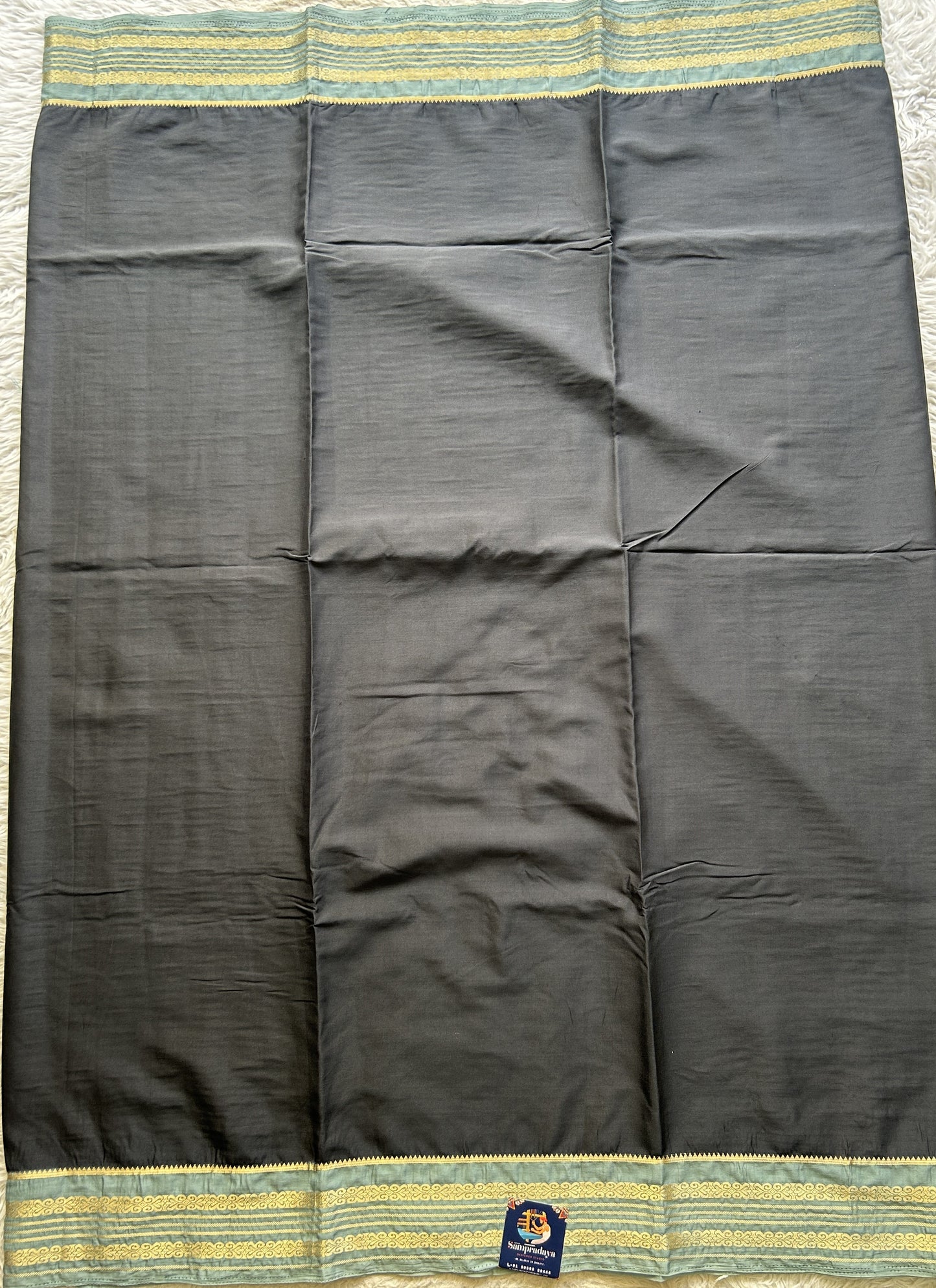 Semi Georgette Saree Elephant Gray Colored elegantly adorned with a Zari Border. - Sampradaya Designer Studio
