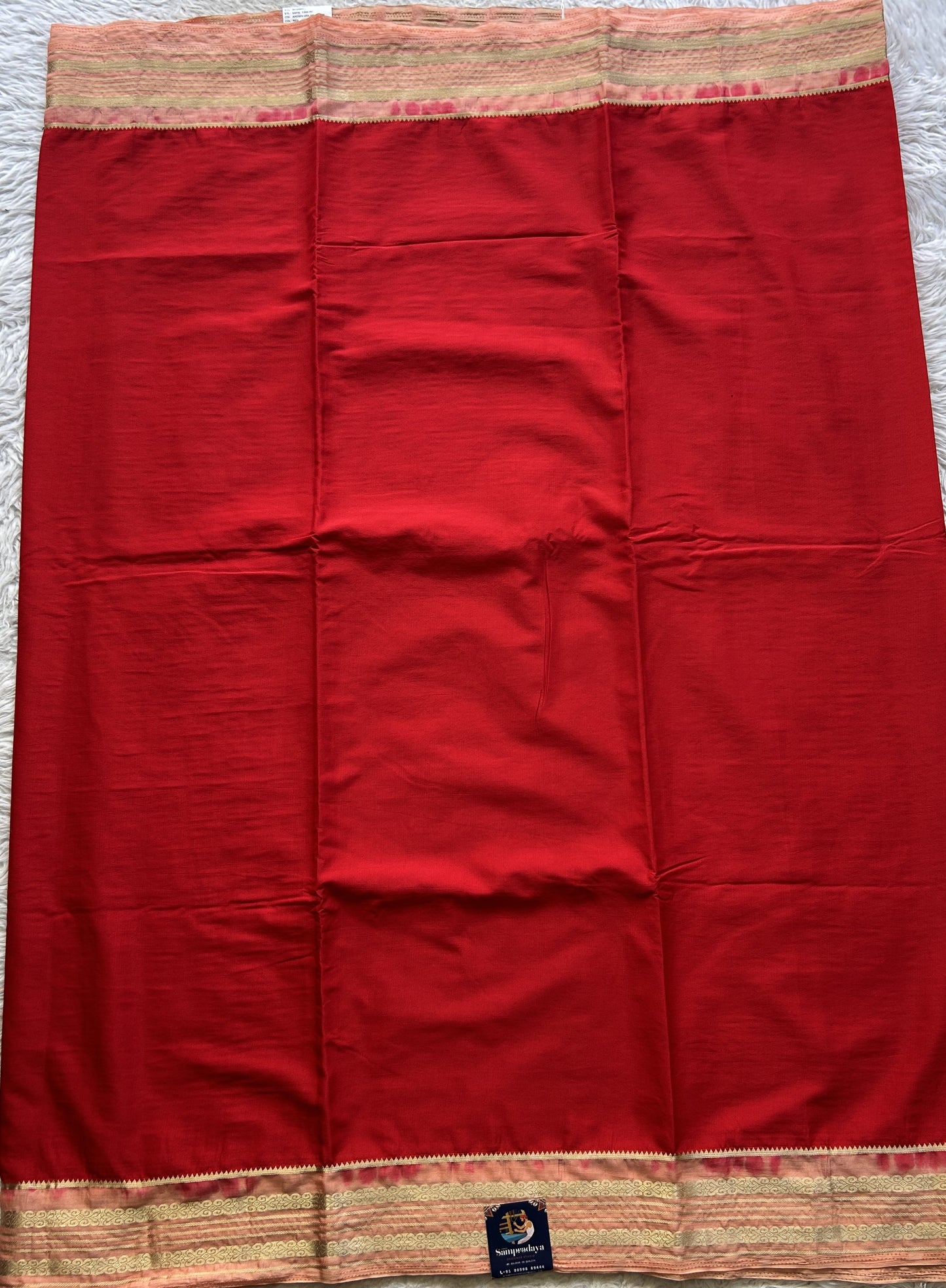 Semi Georgette Saree Red Colored elegantly adorned with a Zari Border. - Sampradaya Designer Studio