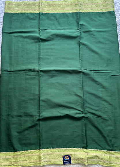 Semi Georgette Saree Dark Green Colored elegantly adorned with a Zari Border. - Sampradaya Designer Studio