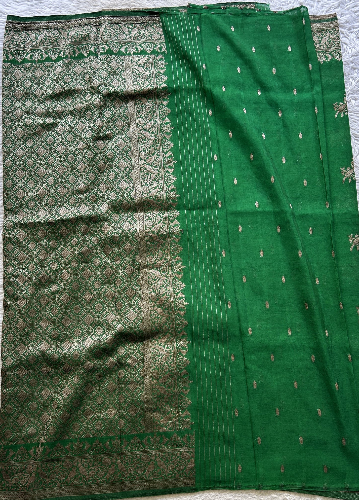 Semi Georgette Saree Green Colored elegantly adorned with a Zari Border. - Sampradaya Designer Studio