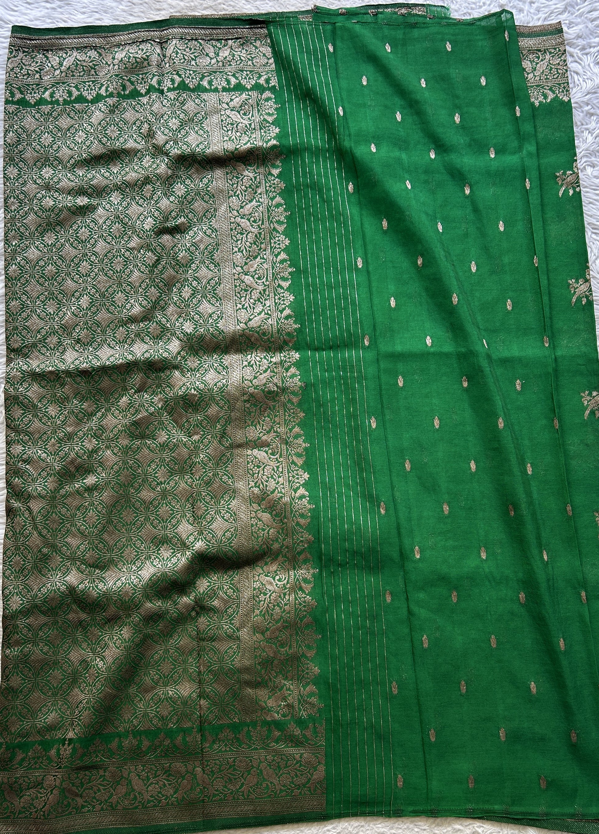 Semi Georgette Saree Green Colored elegantly adorned with a Zari Border. - Sampradaya Designer Studio