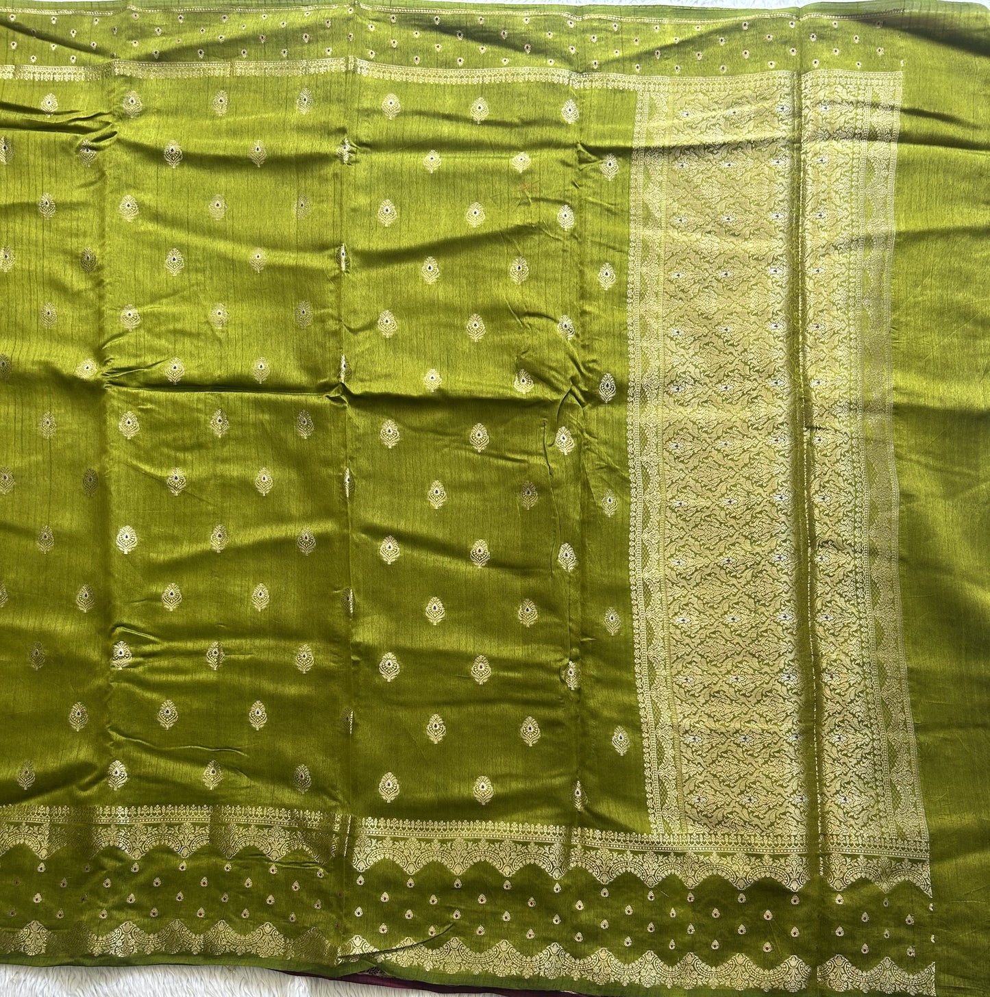 Banarasi Fancy Saree Strong Olive Green Colored Complemented with a Gold Zari Border.