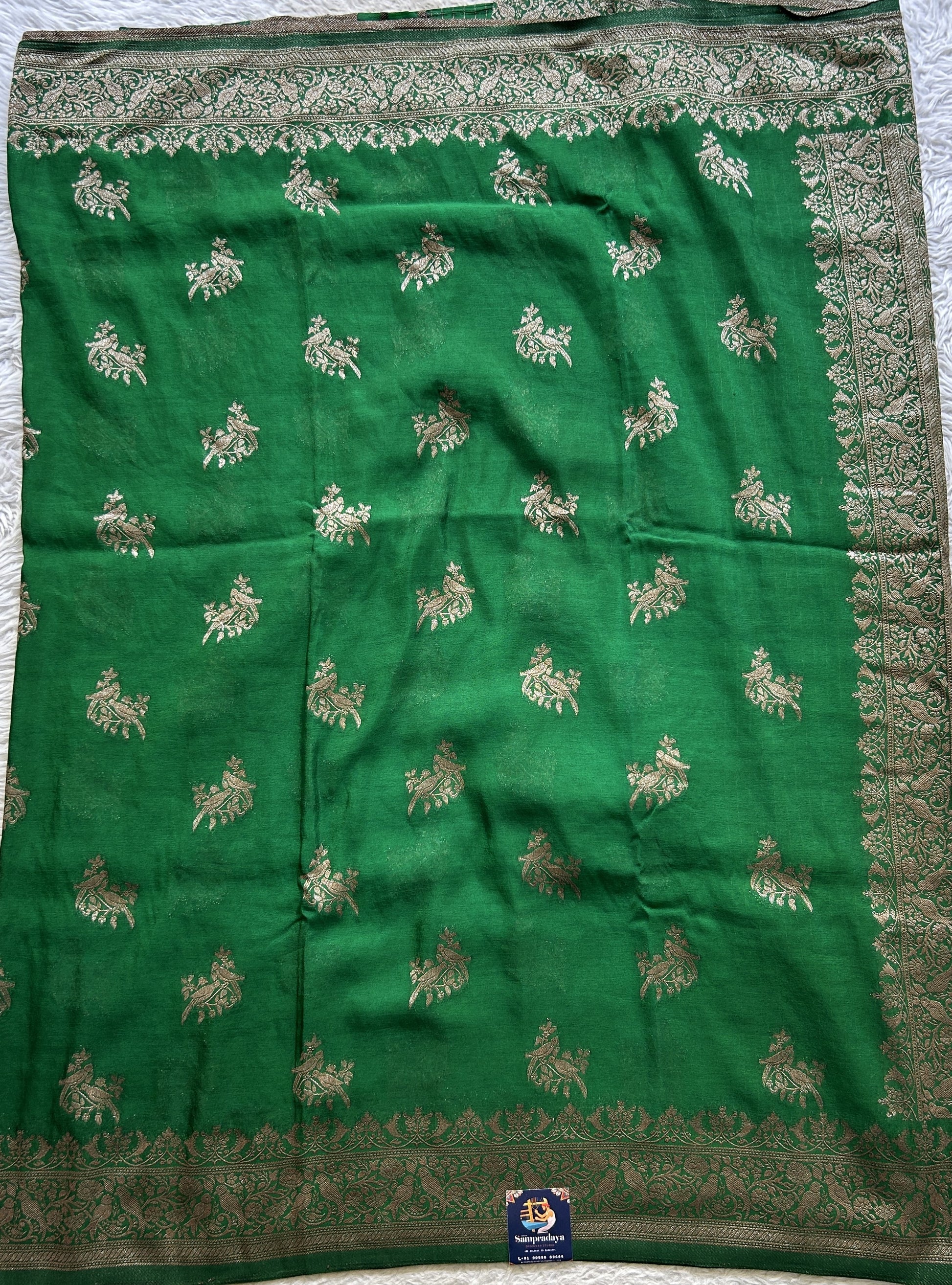 Semi Georgette Saree Green Colored elegantly adorned with a Zari Border. - Sampradaya Designer Studio