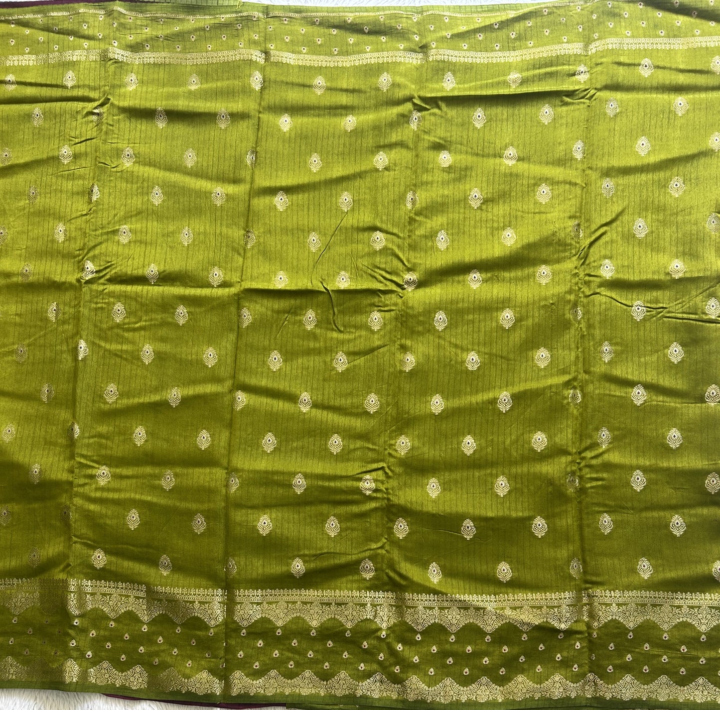 Banarasi Fancy Saree Strong Olive Green Colored Complemented with a Gold Zari Border.