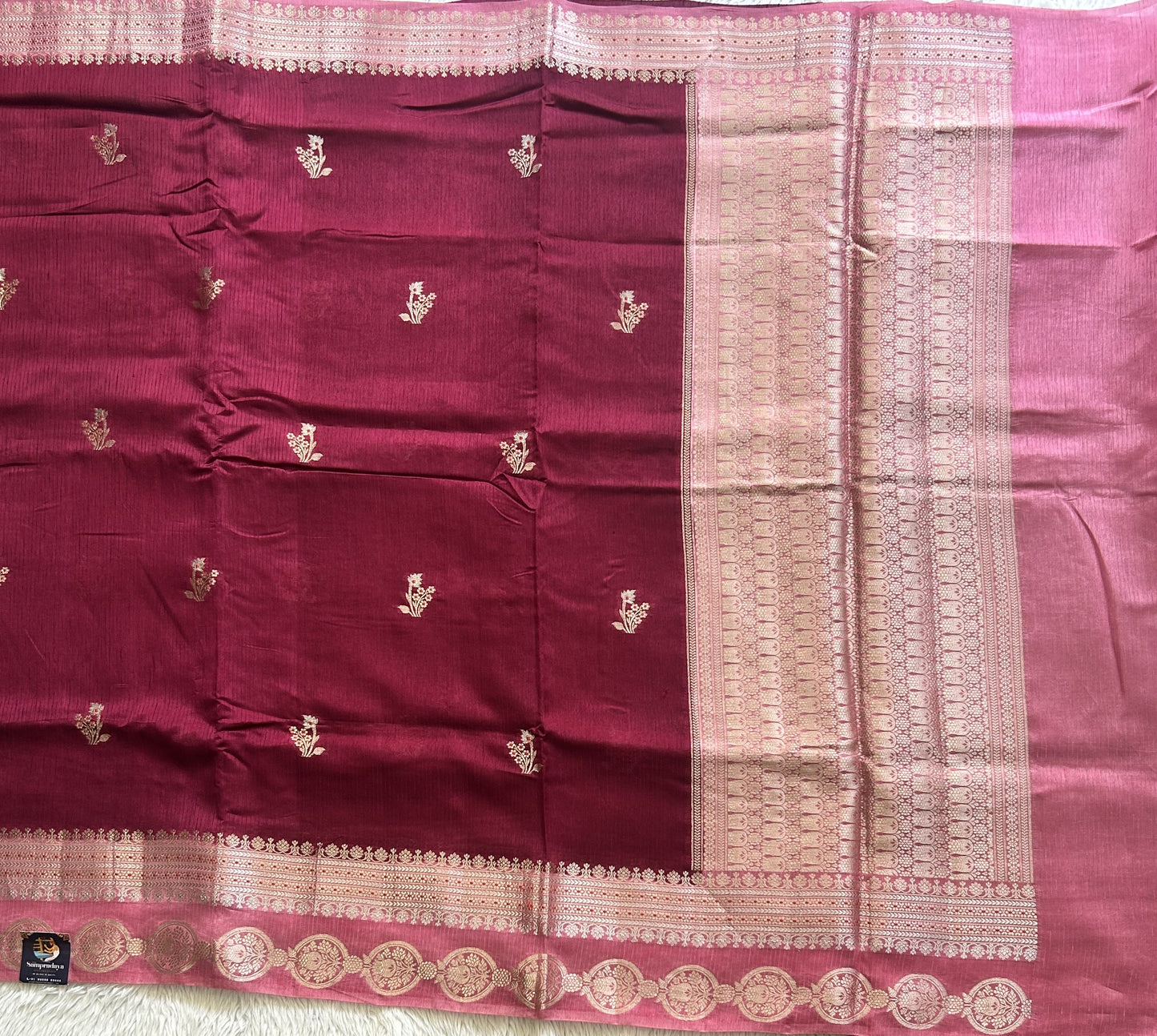 Banarasi Fancy Saree Violet Colored Complemented with a Silver Zari Border.