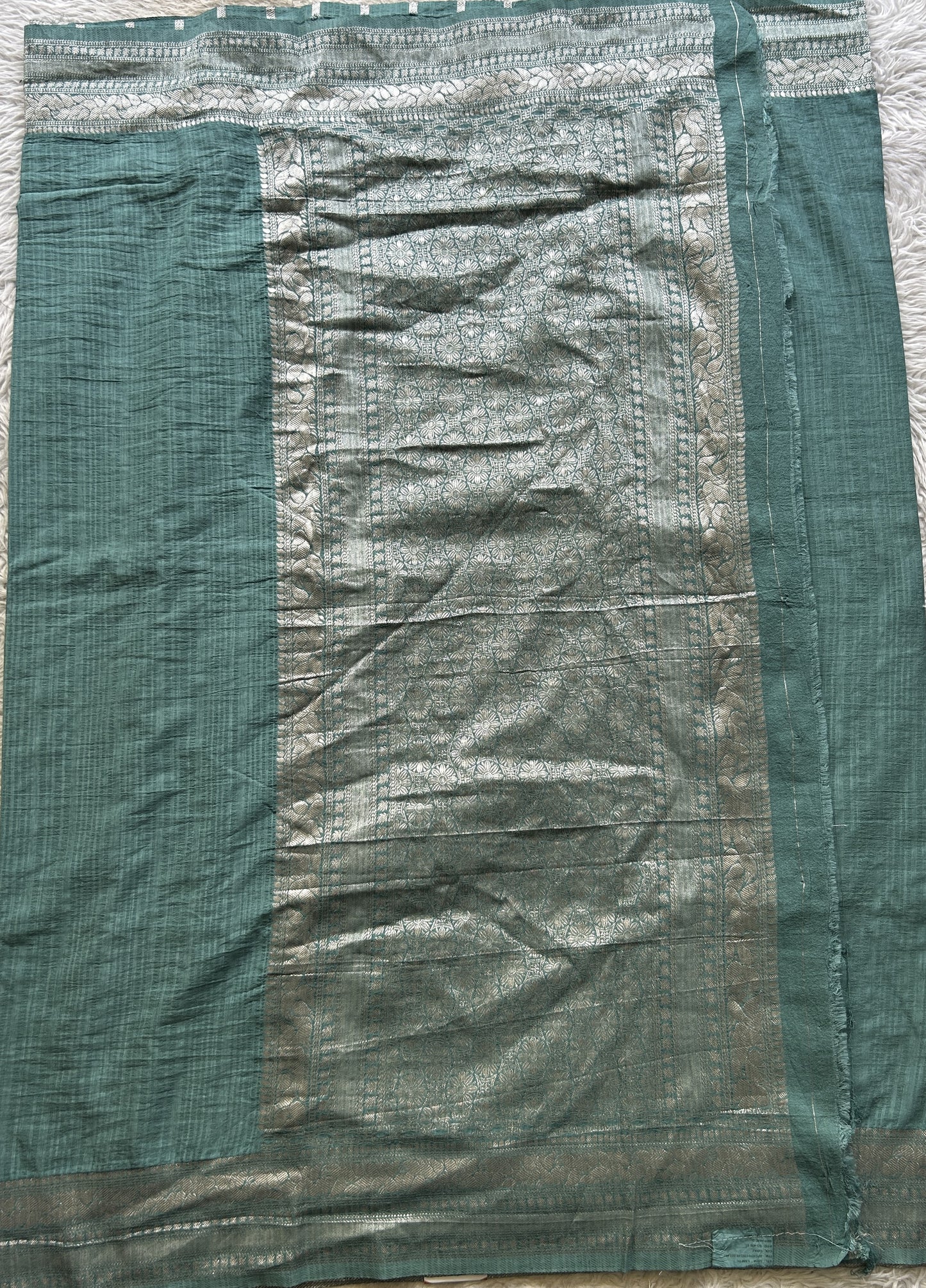 Semi Georgette Saree Sea Blue Colored elegantly adorned with a Zari Border. - Sampradaya Designer Studio