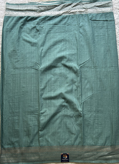 Semi Georgette Saree Sea Blue Colored elegantly adorned with a Zari Border. - Sampradaya Designer Studio