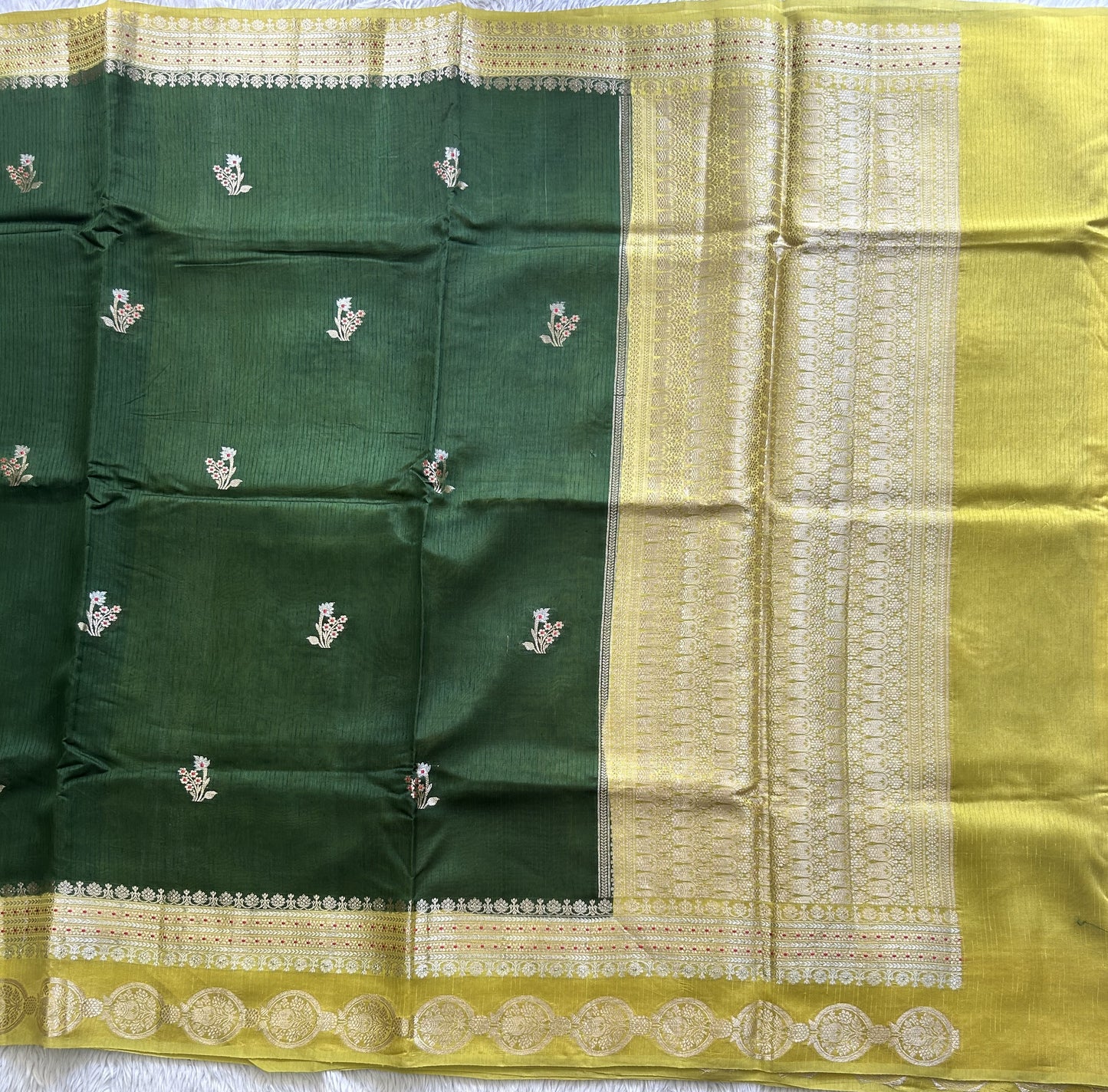 Banarasi Fancy Saree Jungle Green Colored Complemented with a Gold Zari Border.