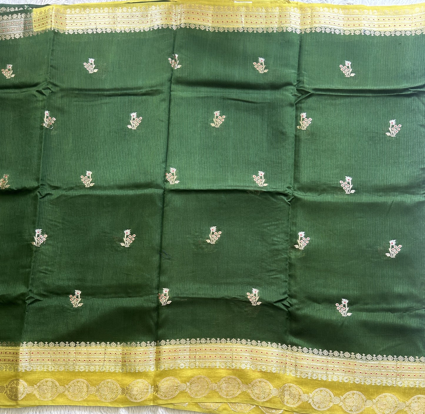 Banarasi Fancy Saree Jungle Green Colored Complemented with a Gold Zari Border.